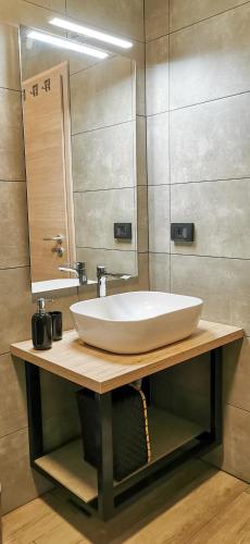 a bathroom with a white sink and a mirror at Casa Grzina in Rovinj