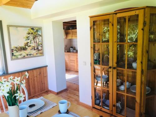 a room with a wooden cabinet with dishes in it at Altja Villa Guesthouse in Vergi