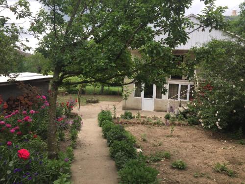 a garden in front of a house with flowers at GoGni OLD ROOM in Gogni