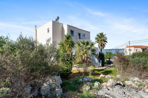 a white house with a bird on top of it at Villa Diana BY APOKORONAS-VILLAS in Plaka