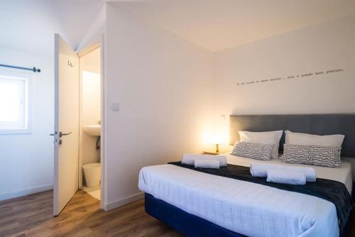 a bedroom with a large bed with two pillows on it at What Else - Fatima in Fátima