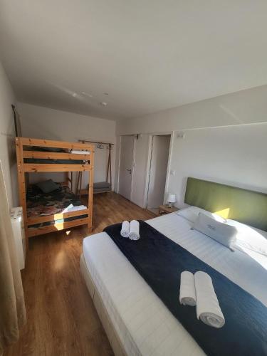 a bedroom with a large bed with two towels on it at What Else - Fatima in Fátima