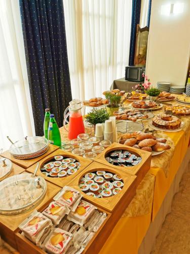 a long table filled with different types of food at Hotel Arabesco in Rimini