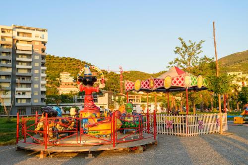 a carnival ride in a park with a carousel at DANTE APARTAMENT in Vlorë