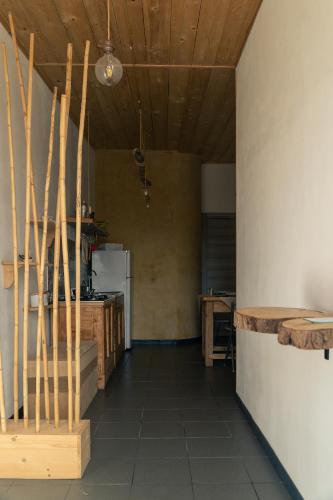 a room with a kitchen with a counter and wooden ceilings at Villa Virginia in Ragusa