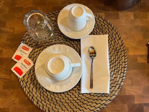 a table with a cup of coffee and a plate and spoon at B&B Fontanelle in Alviano