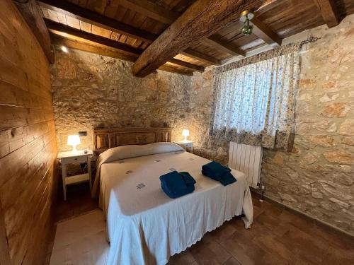 a bedroom with a bed in a room with a stone wall at B&B Fontanelle in Alviano