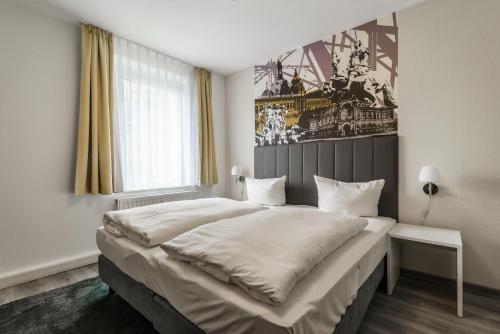 a bedroom with a large bed and a large window at Familienapartment nahe der Frauenkirche in Dresden