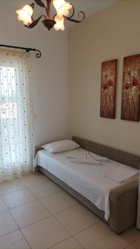 a bedroom with a bed and a chandelier at Magic Land in Plaka