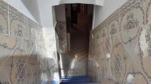 a hallway with white walls and blue stairs at Dar Relax Hostel, Gorges de Todra in Tinerhir