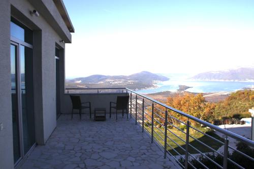 a balcony with chairs and a view of the ocean at Villa Eagle Eye Montenegro in Kotor