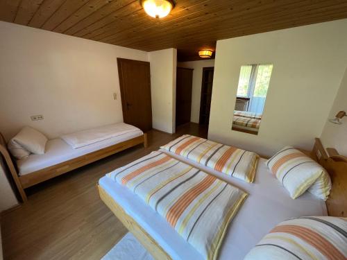 a bedroom with two beds and a window at Gästehaus Edelweiss in Reith bei Seefeld