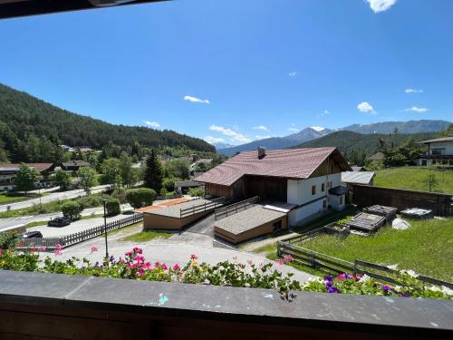 a view from a balcony of a building with flowers at Gästehaus Edelweiss in Reith bei Seefeld