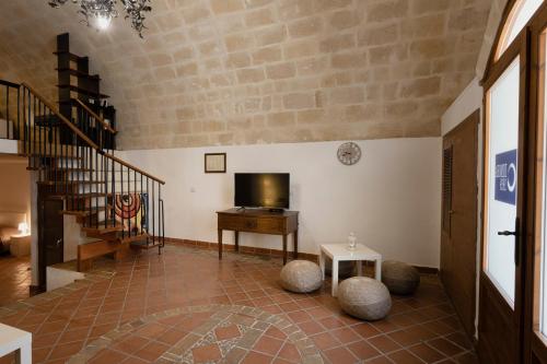 a living room with a television and a table at Dimora 1919 Luxury Loft in Matera