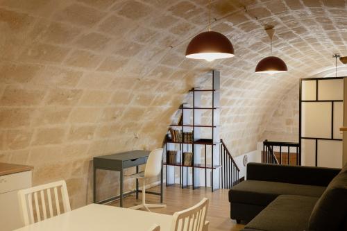 a living room with a brick wall at Dimora 1919 Luxury Loft in Matera