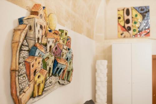 a painting of a building on a wall at Dimora 1919 Luxury Loft in Matera