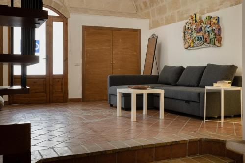 a living room with a couch and a table at Dimora 1919 Luxury Loft in Matera