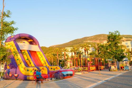 a playground with a slide in a park at DANTE APARTAMENT in Vlorë