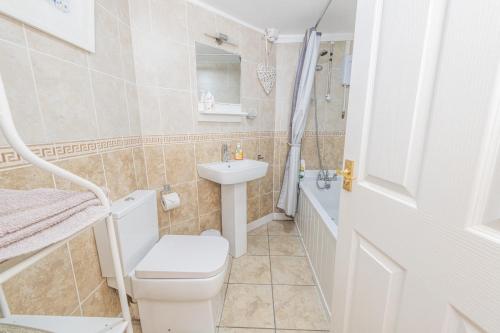 a small bathroom with a toilet and a sink at The Flat at number 11 in Newton Abbot