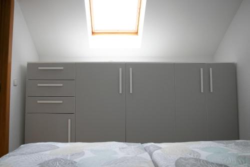 a bedroom with a bed with a dresser and a mirror at Lusht'n apartma in Žirovnica
