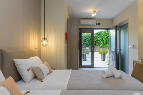 a bedroom with a bed and a sliding glass door at Casa De' Fiori Kefalonia in Skala Kefalonias