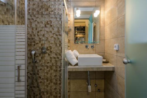 a bathroom with a sink and a shower at Casa De' Fiori Kefalonia in Skala Kefalonias