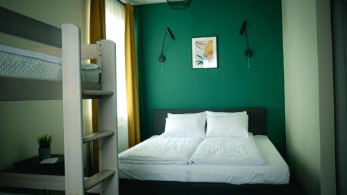 a bedroom with a bunk bed and a ladder at RUMI Hotel with Self Check-In in Jēkabpils