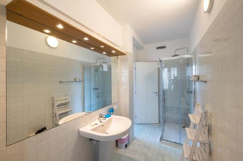 a white bathroom with a sink and a shower at Le Casasse "Paradiso" in Varigotti