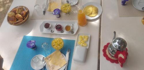 a table with eggs and other breakfast foods on it at MAROC LODGE Atlas Mountain Retreat in Amizmiz