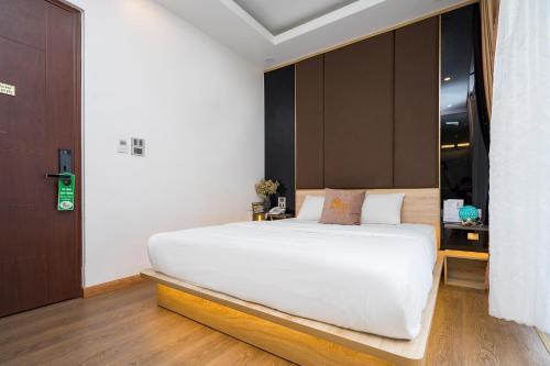 a bedroom with a large white bed in a room at BBQ HOSTEL in Ha Long