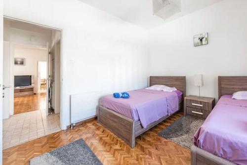 a bedroom with two beds and a living room at Myria Court in Limassol
