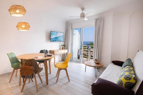 a living room with a table and a dining room at ALTAVISTA APARTAHOTEL-Adults Only over 14 in Morro del Jable