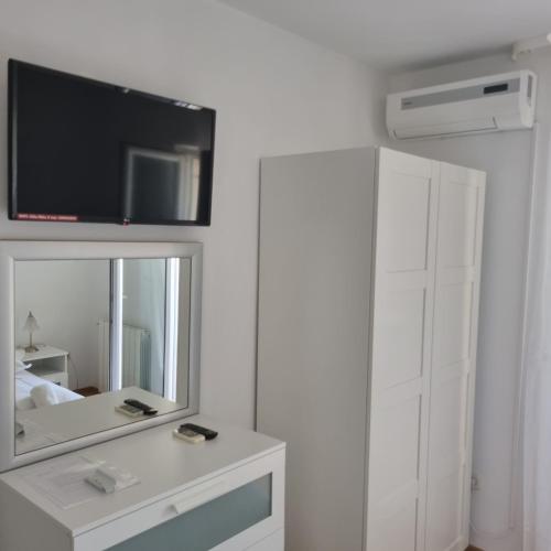a bedroom with a mirror and a tv on a wall at Villa Mila in Bol