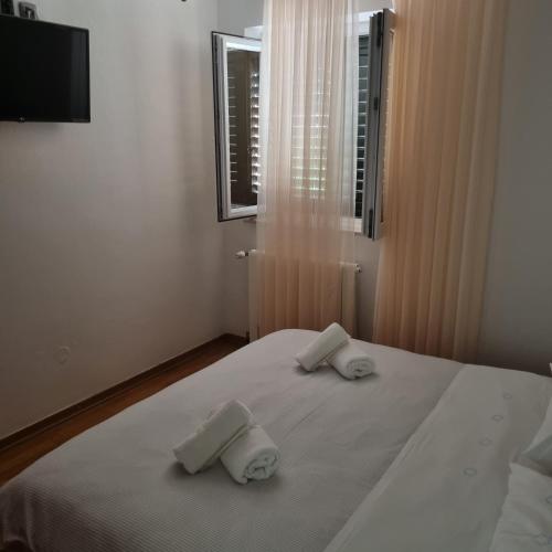 a bedroom with a bed with two towels on it at Villa Mila in Bol