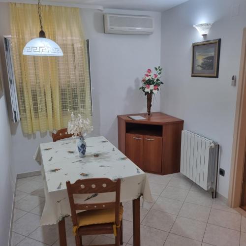 a dining room with a white table and chairs at Villa Mila in Bol