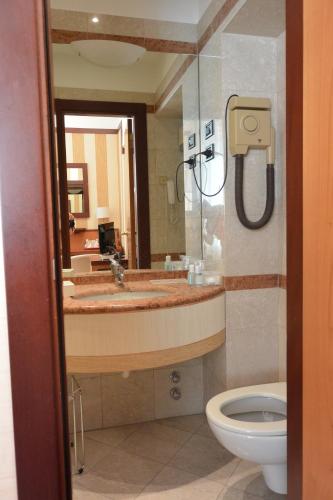 a bathroom with a sink and a toilet at Hotel Metrò in Milan