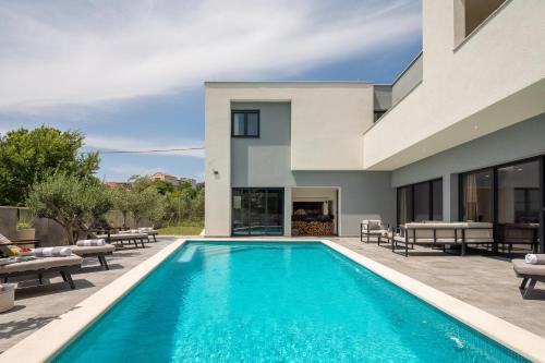 a swimming pool in the backyard of a house at Luxury Villa IN with Heated Pool in Solin