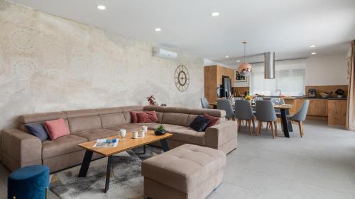 a living room with a couch and a table at Luxury Villa IN with Heated Pool in Solin