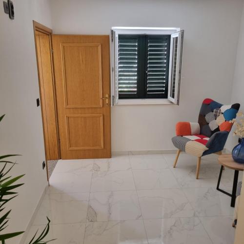 a room with a door and a chair and a window at Villa Mila in Bol