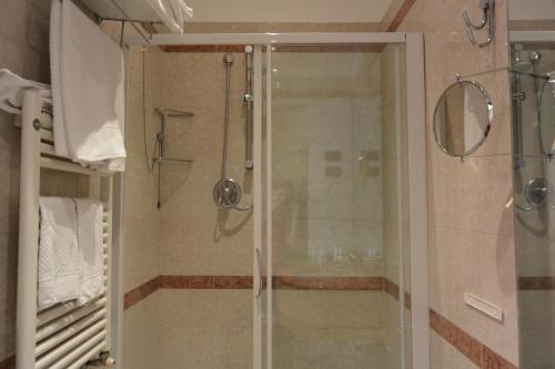a shower with a glass door in a bathroom at Hotel Metrò in Milan