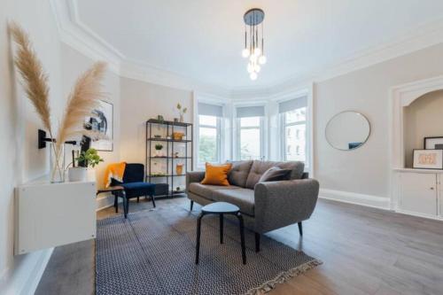 a living room with a couch and a table at Stylish Stirling Apartment - free parking in Stirling