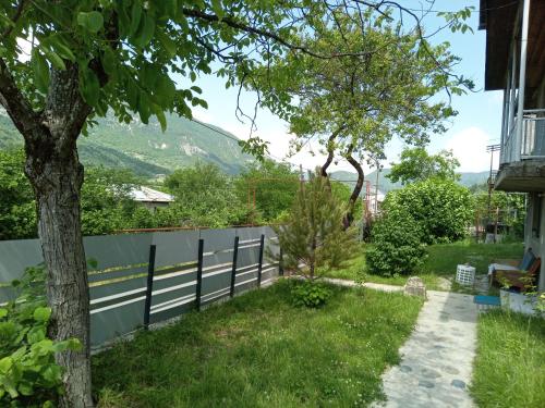a fence with a view of a mountain at Villa PorTina in Ambrolauri