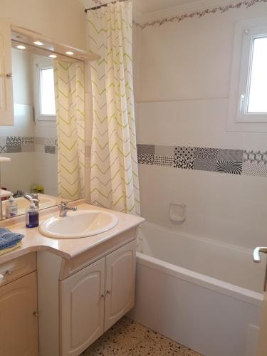 a bathroom with a sink and a shower curtain at City Break in Narbonne