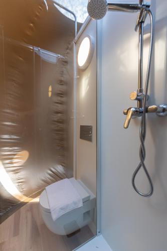 a bathroom with a shower with a toilet at La Rocca Camping Village in Bardolino
