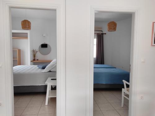 a bedroom with a bed and a table and a mirror at Ammos Sifnos Village in Platis Yialos Sifnos