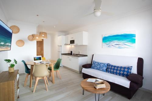 a living room with a couch and a table at ALTAVISTA APARTAHOTEL-Adults Only over 14 in Morro del Jable