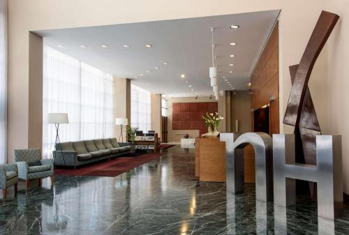 a lobby of a hotel with a hotel sign on the floor at NH Buenos Aires Latino in Buenos Aires