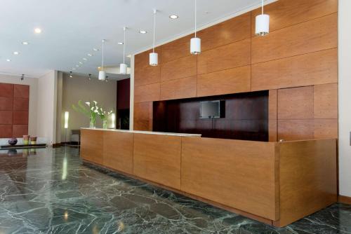a large lobby with a large wooden wall at NH Buenos Aires Latino in Buenos Aires