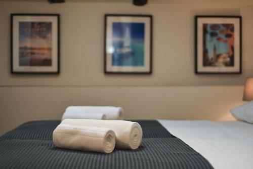 a hotel room with two towels on a bed at Old Town Inn in Pula