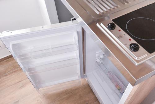 an empty refrigerator with its door open in a kitchen at Old Town Inn in Pula